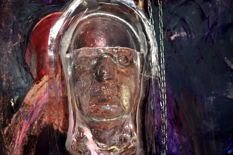 Studio image, Symbiotic Illusion (suspended plastic head filled with water and lit)